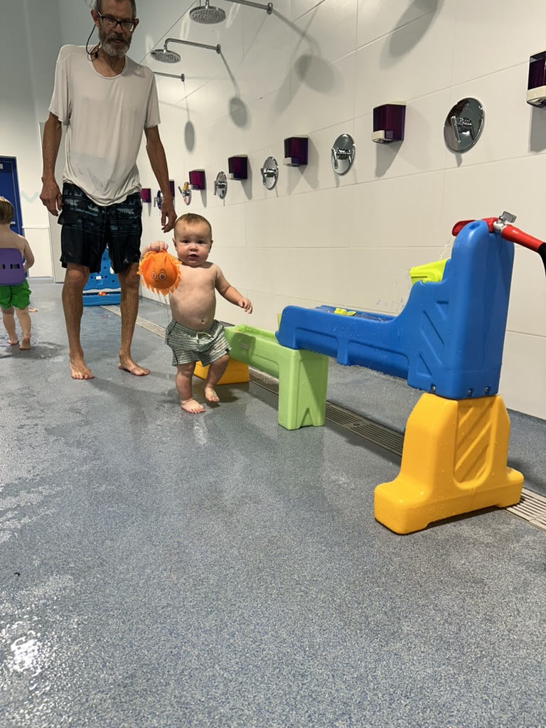 Toddler and dad on the pool deck
